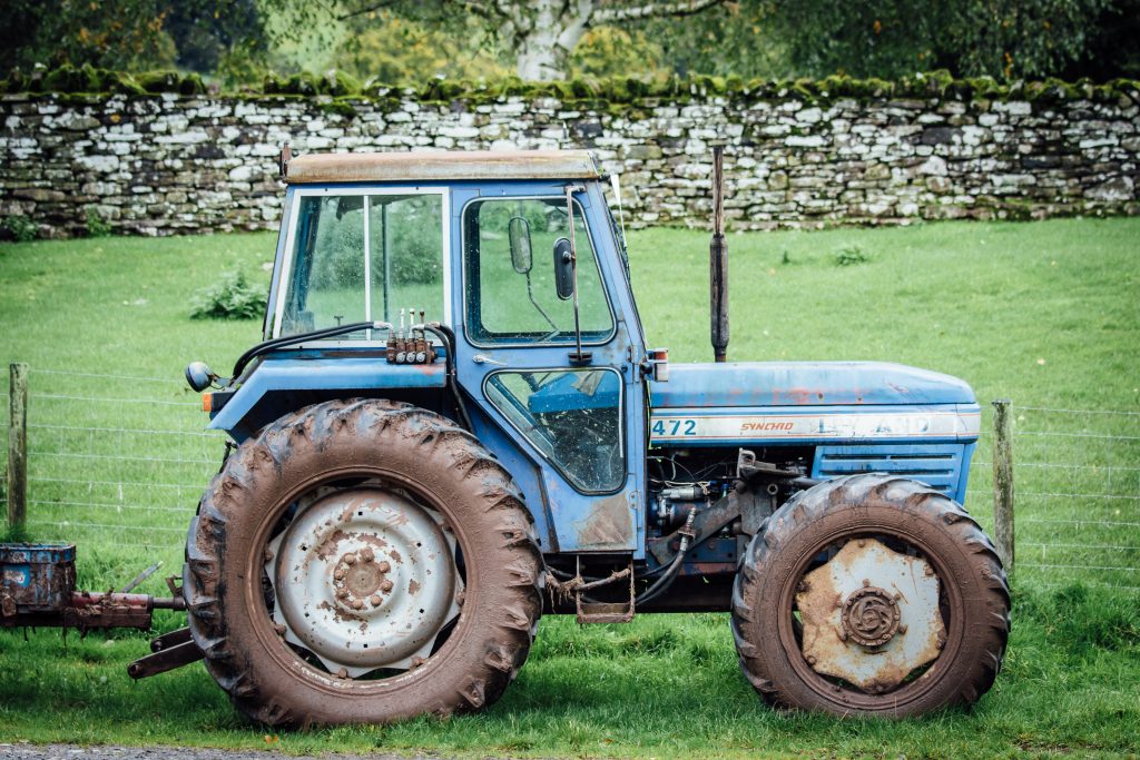 old blue tractor on the farm yard